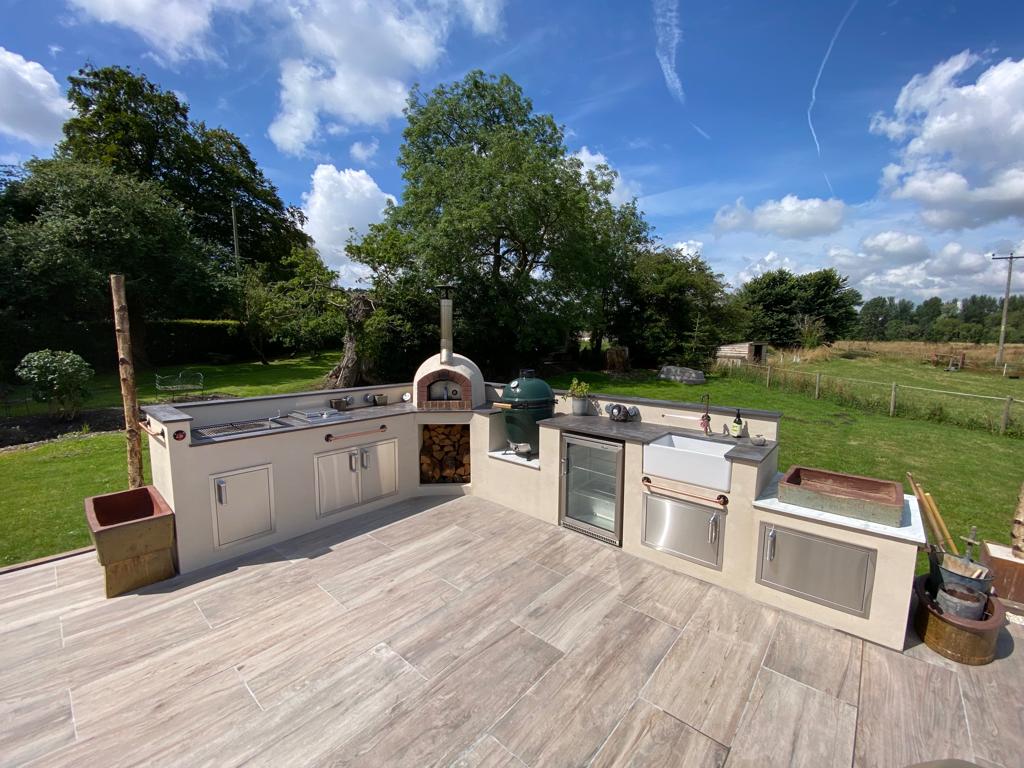 completed outdoor kitchen with built in pizza oven.