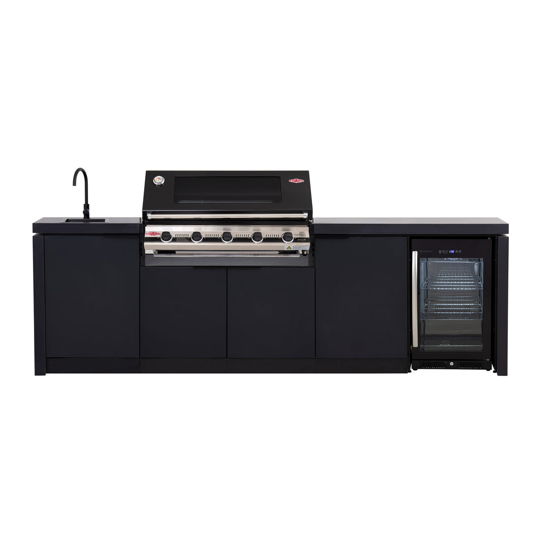 A black outdoor kitchen cabinet set with a 5 burner grill on top, a bar fridge to the side, a mixer tap and sink, and cupboards.