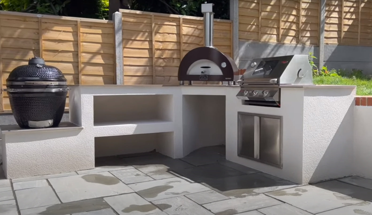 l-shaped outdoor kitchen with white render finish