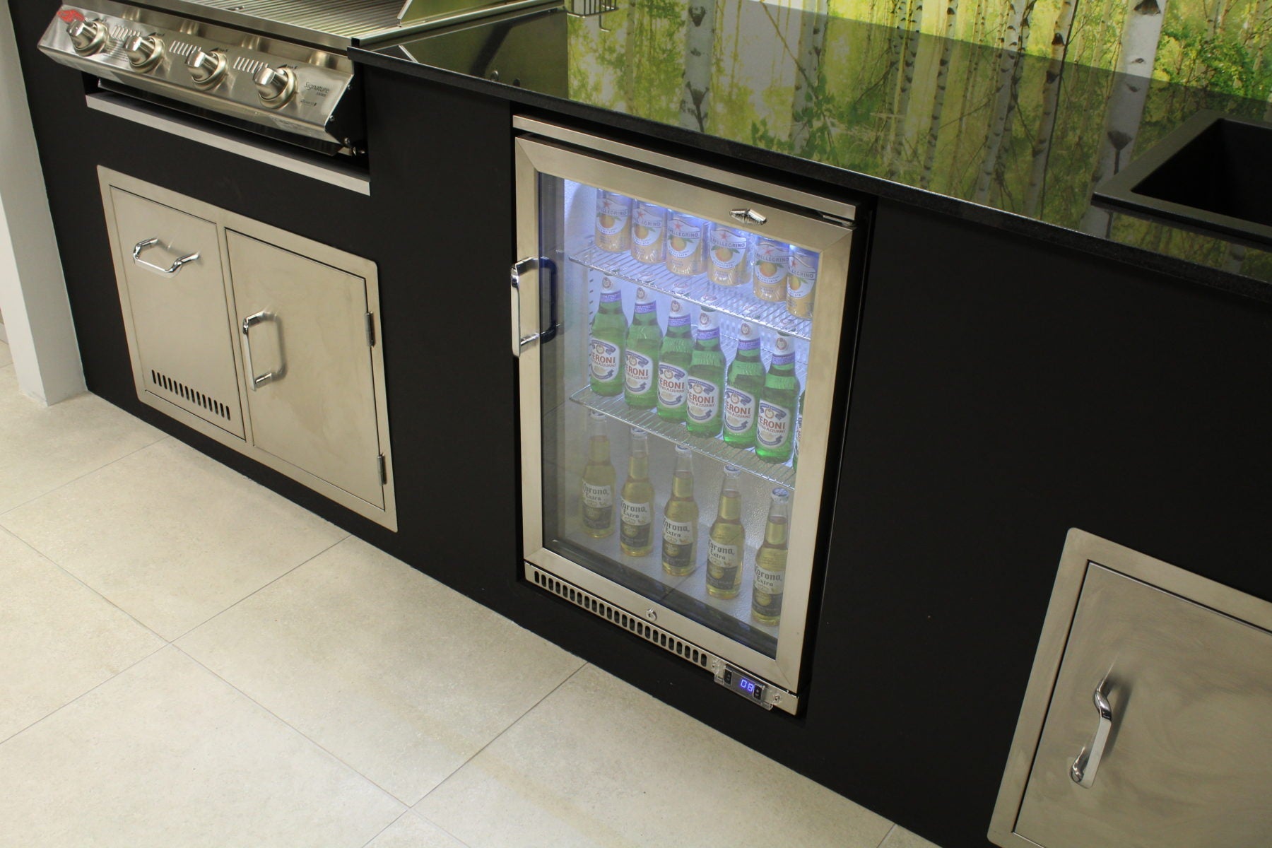 outdoor fridge fitted in outdoor kitchen with black granite worktop