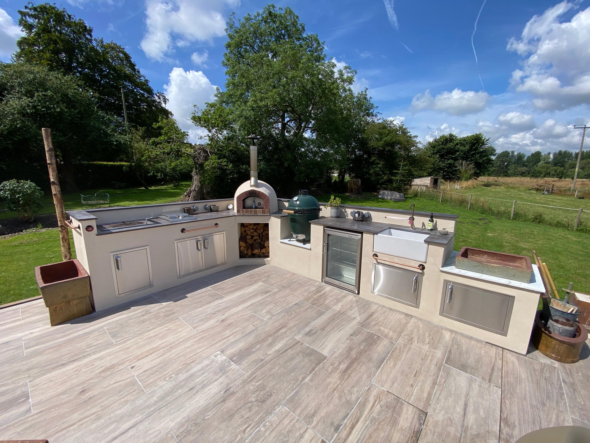 rendered country garden outdoor kitchen, with built in pizza oven and space for outdoor fridge